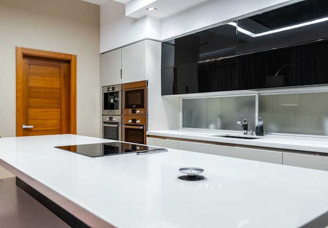 inside-modern-kitchen-with-white-countertops-and-cabinets