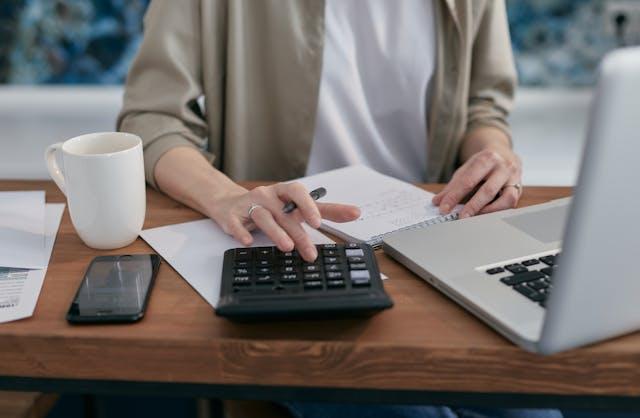 A person paying rent online with a card
